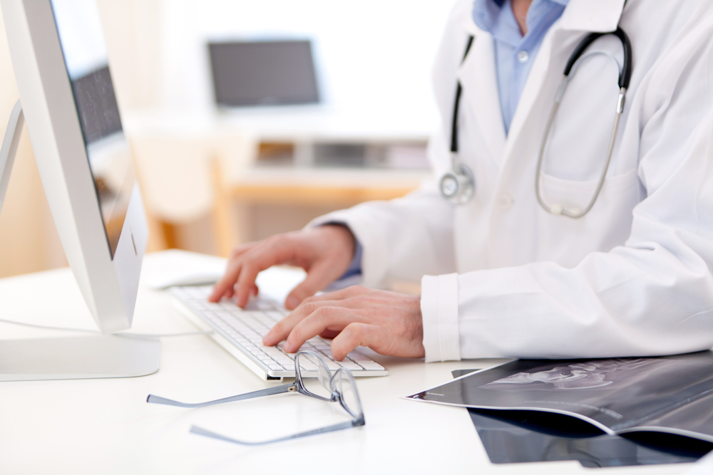 Doctor checking health record of patient online