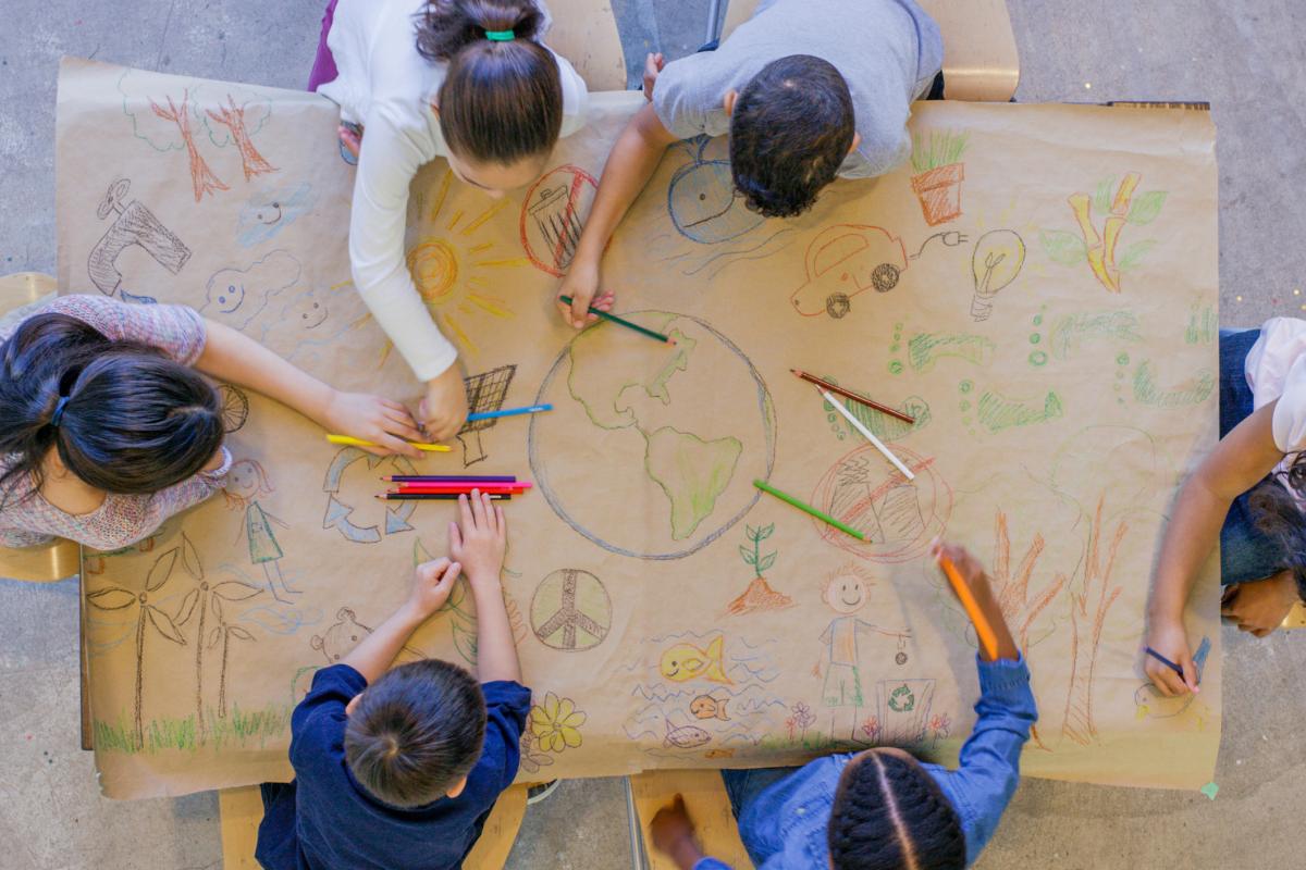 children drawing on a big paper