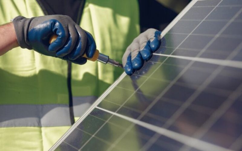 close-up of a working installing solar panels