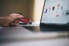 Person holding a credit card while buying online