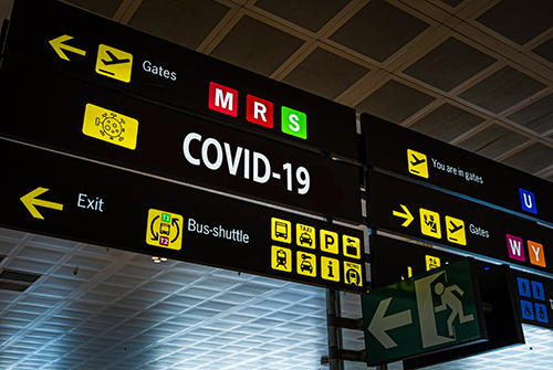 Airport board with covid sign