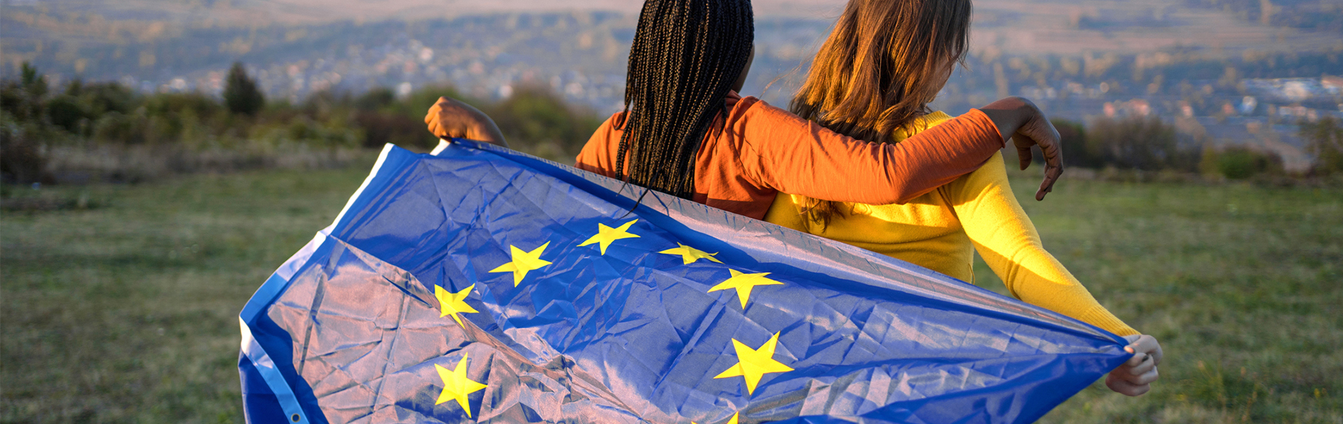 Two ladies holding the EU flag