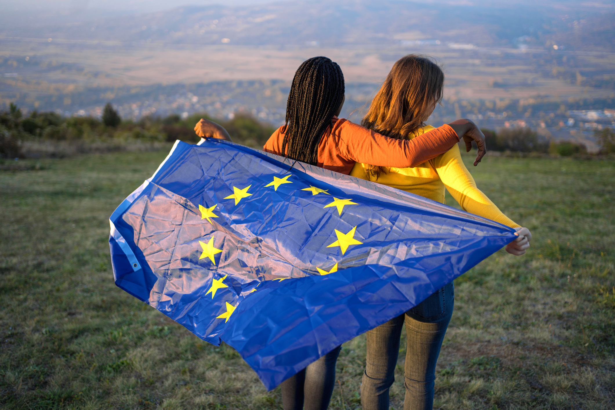 Young ladies holding the EU flag