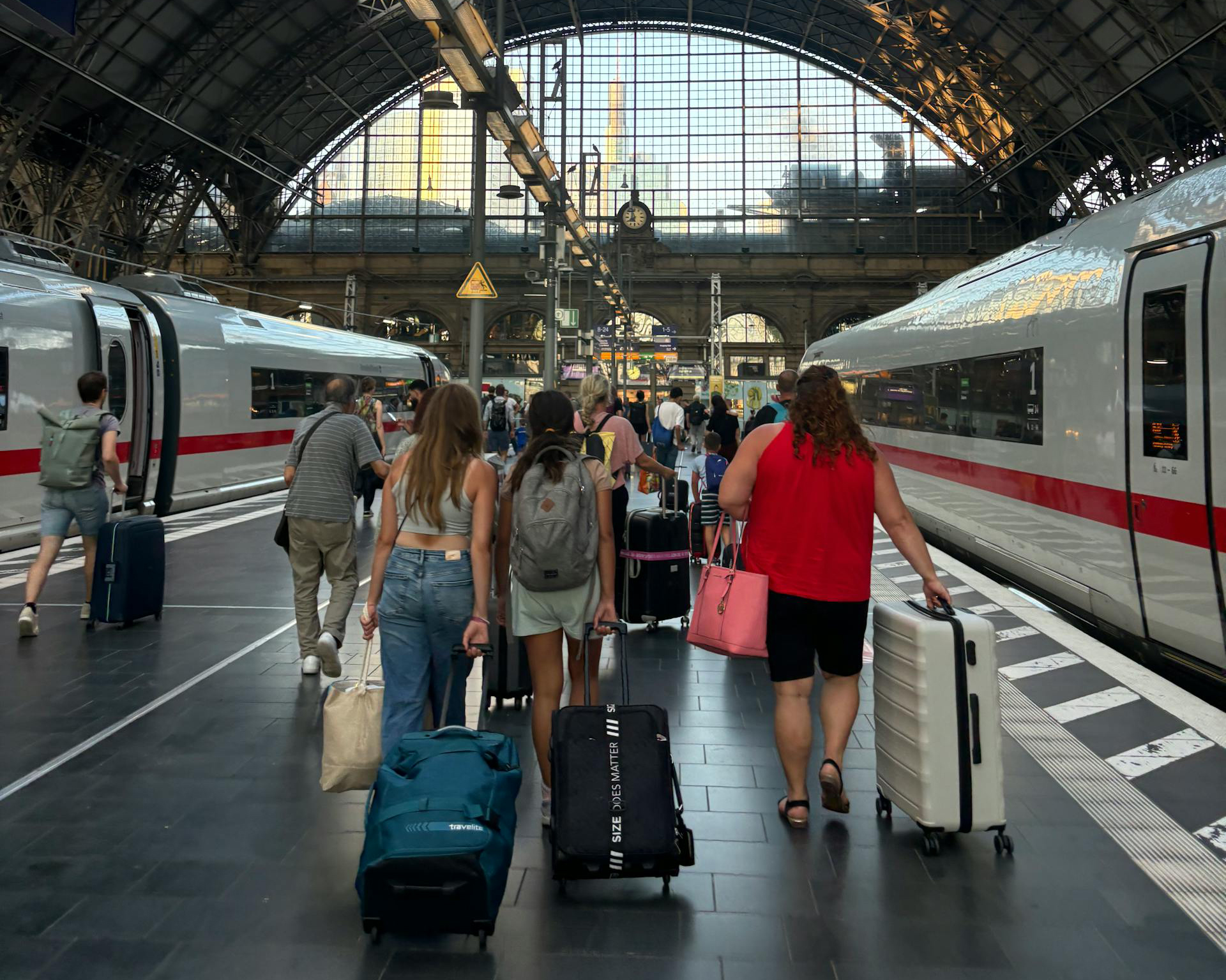 Passengers with suitcases in train station