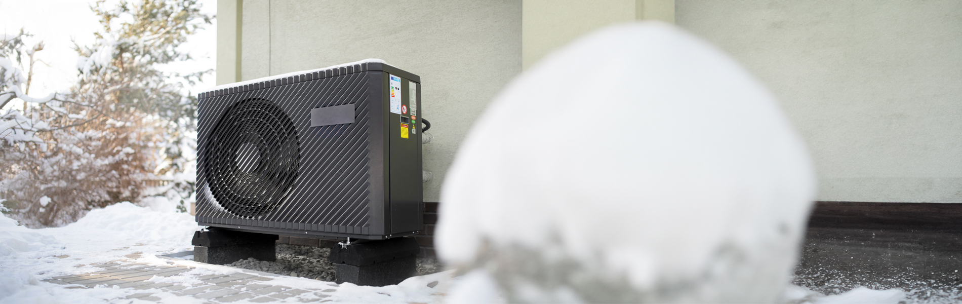 heat pump against wall in snow