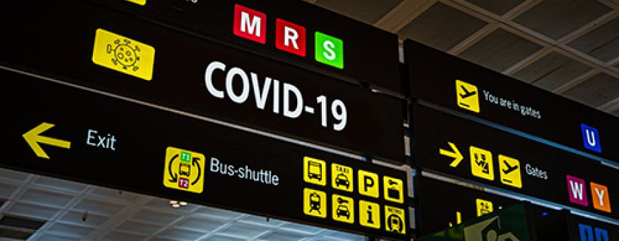 Airport board with covid sign