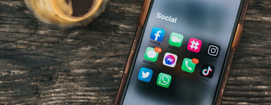 Phone on table with social media apps
