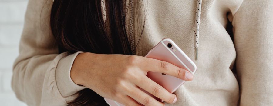 Girl holding a light pink phone