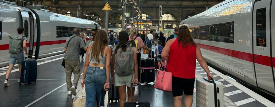 Passengers with suitcases in train station
